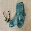 blue hand knit socks on a textured background